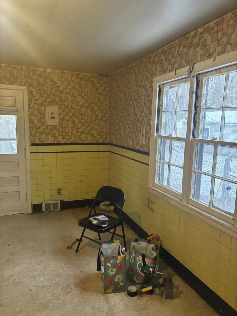 Room with old wallpaper and tile before interior demo Detroit